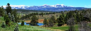 The mountains behind a pagosa springs lake